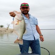 Angler with great black bass Lake El Cuchillo