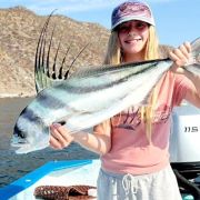 Girl catches a roosterfish in Bahía de los Sueños