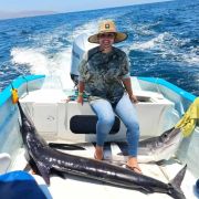 Proud angler and her swordfish catch at Ensenada de los Muertos